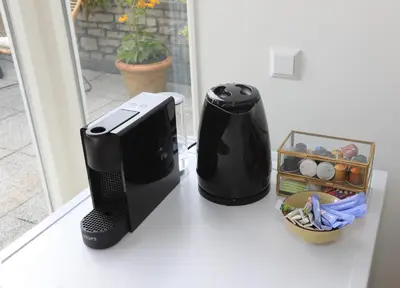 a computer printer and a coffee maker on a counter at B&B De Zwanebloem in Amsterdam