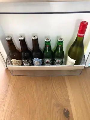 a drawer full of beer bottles in a refrigerator at B&B De Zwanebloem in Amsterdam