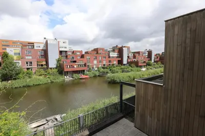 a view of a river in a city with buildings at B&B De Zwanebloem in Amsterdam