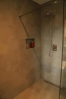 a bathroom with a shower with a glass door at B&B De Zwanebloem in Amsterdam