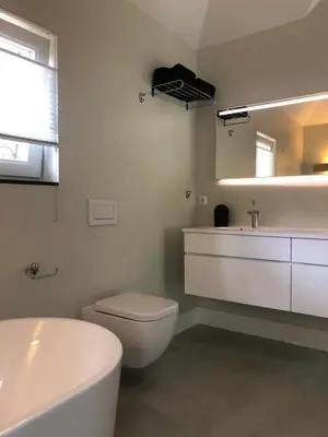 a bathroom with a toilet and a sink and a mirror at Modern Palace Emma Staete in Baarn