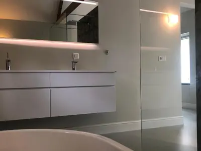 a bathroom with a sink and a glass shower at Modern Palace Emma Staete in Baarn