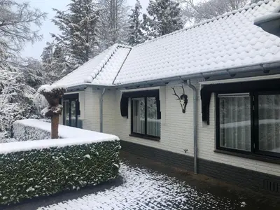 a house with snow on the roof of it at Modern Palace Emma Staete in Baarn