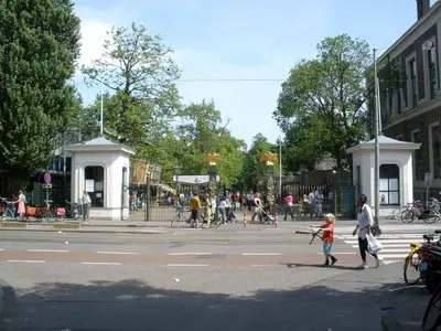 a group of people crossing a street in a city at Quiet apartment for 4 at park in center in Amsterdam