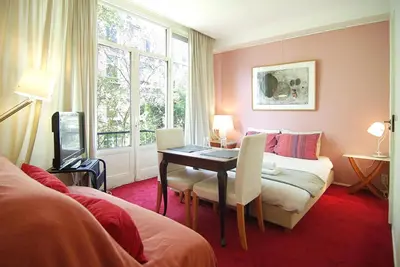 a room with a desk and a bed and a couch at Wooden Mill B&B in Amsterdam