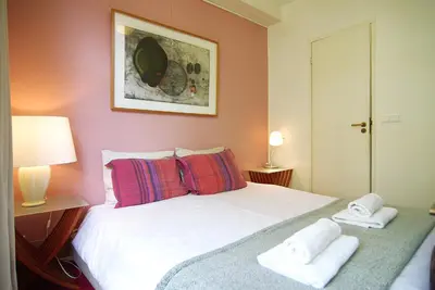 a bedroom with a bed with towels on it at Wooden Mill B&B in Amsterdam