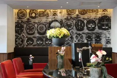 a restaurant with a wall with plates on it at Bastion Hotel Amsterdam Airport in Hoofddorp