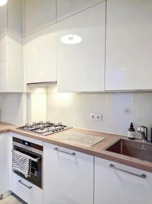 a white kitchen with a stove and a sink at A cozy place in Amsterdam in Amsterdam