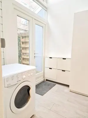 a laundry room with a washing machine and a window at A cozy place in Amsterdam in Amsterdam