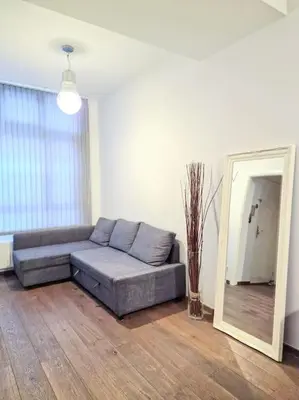 a living room with a couch and a mirror at A cozy place in Amsterdam in Amsterdam