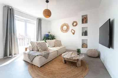a living room with a couch and a tv at Bamboa Beachhouse in Zandvoort