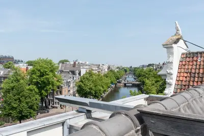 a view of a river from the roof of a building at Empire suites garden view in Amsterdam