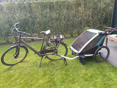 a bike with a cart parked in the grass at Ferienhaus Weitblick in Sint Maarten