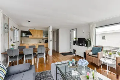 a living room with a couch and a table at Bright and Comfortable Houseboat in Aalsmeer
