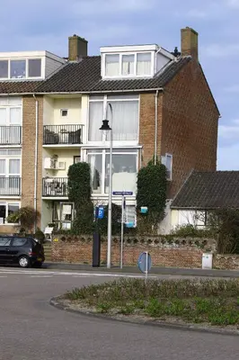 a building with a street sign in front of it at Studio Sautille in Zandvoort
