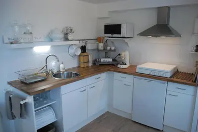 a kitchen with a sink and a counter top at Studio Sautille in Zandvoort
