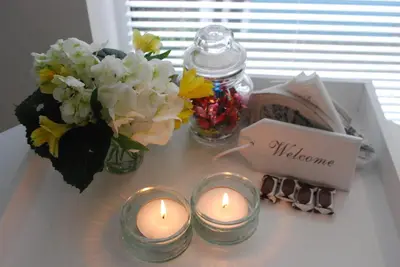 a table with candles and flowers and a vase of flowers at Studio Sautille in Zandvoort