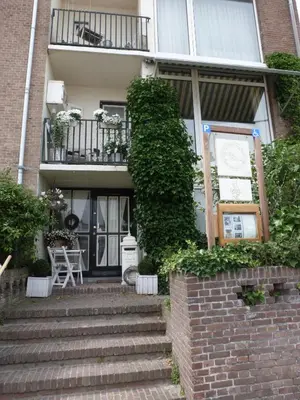 a building with stairs leading up to the front door at Studio Sautille in Zandvoort