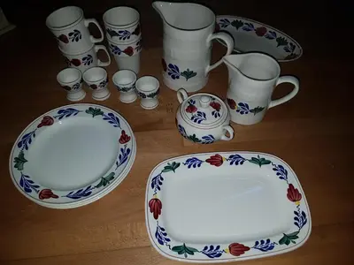 a group of cups and plates on a table at Bed & Breakfast De Koegang in Zuidermeer