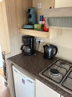 a kitchen with a stove and a counter top at Chalet De Duinberg in IJmuiden