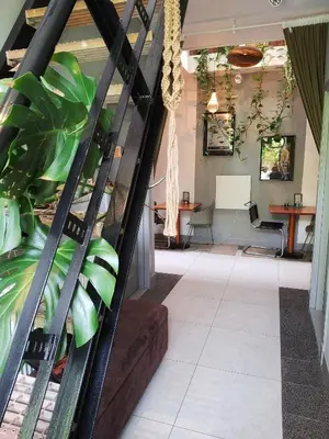 a lobby with plants and a table in the background at Inn the Green in Zeist