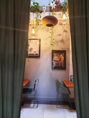 a restaurant with a table and chairs and lights at Inn the Green in Zeist