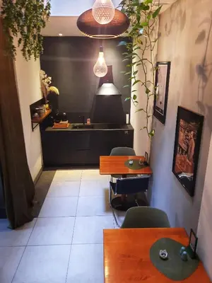 a restaurant with tables and chairs and a counter at Inn the Green in Zeist