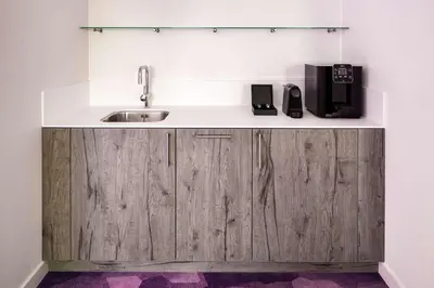 a kitchen with a sink and a counter at YOTEL Amsterdam in Amsterdam