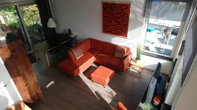 an overhead view of a living room with a red couch at Houseboat Vliegenbos in Amsterdam
