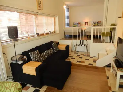 a living room with a couch and a bed at Apartment Amsterdam New West - Free parking in Amsterdam