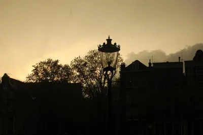 a silhouette of a street light in front of buildings at Amsterdam House of Arts & Crafts in Amsterdam