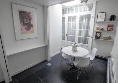 a dining room with a table and chairs and a window at Waterland Hoge Huis in Monnickendam