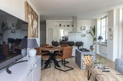 a living room with a table and a couch at casa Heemskerk in Noordwijk