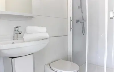 a white bathroom with a sink and a toilet at Madrid in Lelystad