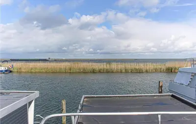 a boat is docked on a body of water at Madrid in Lelystad