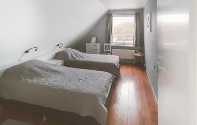 two twin beds in a room with a window at Pet Friendly Home In Zeewolde With Wifi in Zeewolde