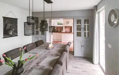 a dining room with a long table and chairs at Pet Friendly Home In Zeewolde With Wifi in Zeewolde