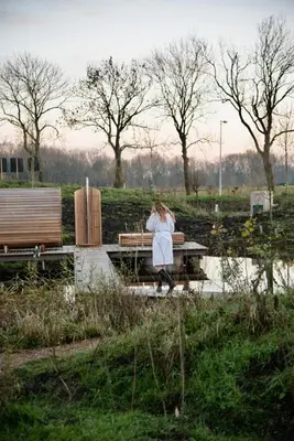 a woman standing on a picnic table in a park at Basecamp Amsterdam in Amsterdam