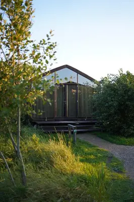a glass house sitting on the side of a road at Basecamp Amsterdam in Amsterdam