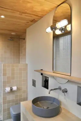 a bathroom with a sink and a mirror at Basecamp Amsterdam in Amsterdam