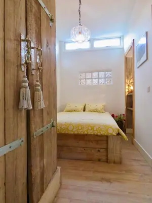 a bedroom with a bed and a wooden wall at Casa duna Oceans terrace and Ocean spray garden close to the beach and city centre in Zandvoort