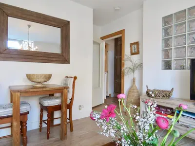 a living room with a table and a mirror at Casa duna Oceans terrace and Ocean spray garden close to the beach and city centre in Zandvoort