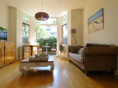 a living room with a couch and a coffee table at Casa duna Oceans terrace and Ocean spray garden close to the beach and city centre in Zandvoort