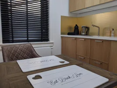a kitchen with a table with two boxes on it at Beachtime Suite in Zandvoort