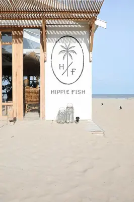 a sign for a surf shop on the beach at Beachtime Suite in Zandvoort