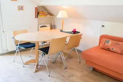 a room with a table and chairs and a couch at Bed and Breakfast Hoorn in Hoorn