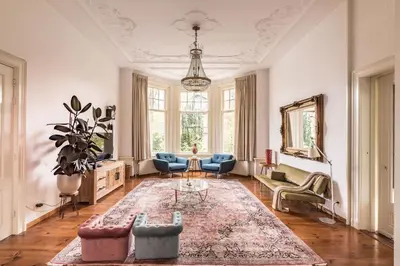 a living room with a couch and chairs and a rug at Boutique Appartement-Hotel Villa Juttershof in Bergen