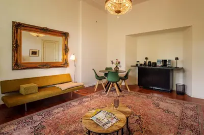 a living room with a couch and a table at Boutique Appartement-Hotel Villa Juttershof in Bergen