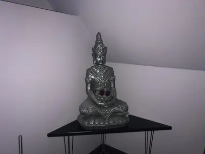 a statue sitting on top of a black table at Bed and Breakfast The Rose in Haarlem