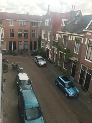 a group of cars parked in a parking lot at Bed and Breakfast The Rose in Haarlem